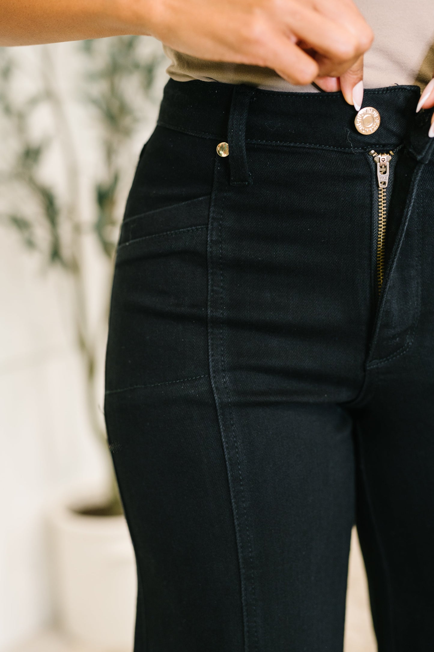 Close-up of black pants with a blurred background