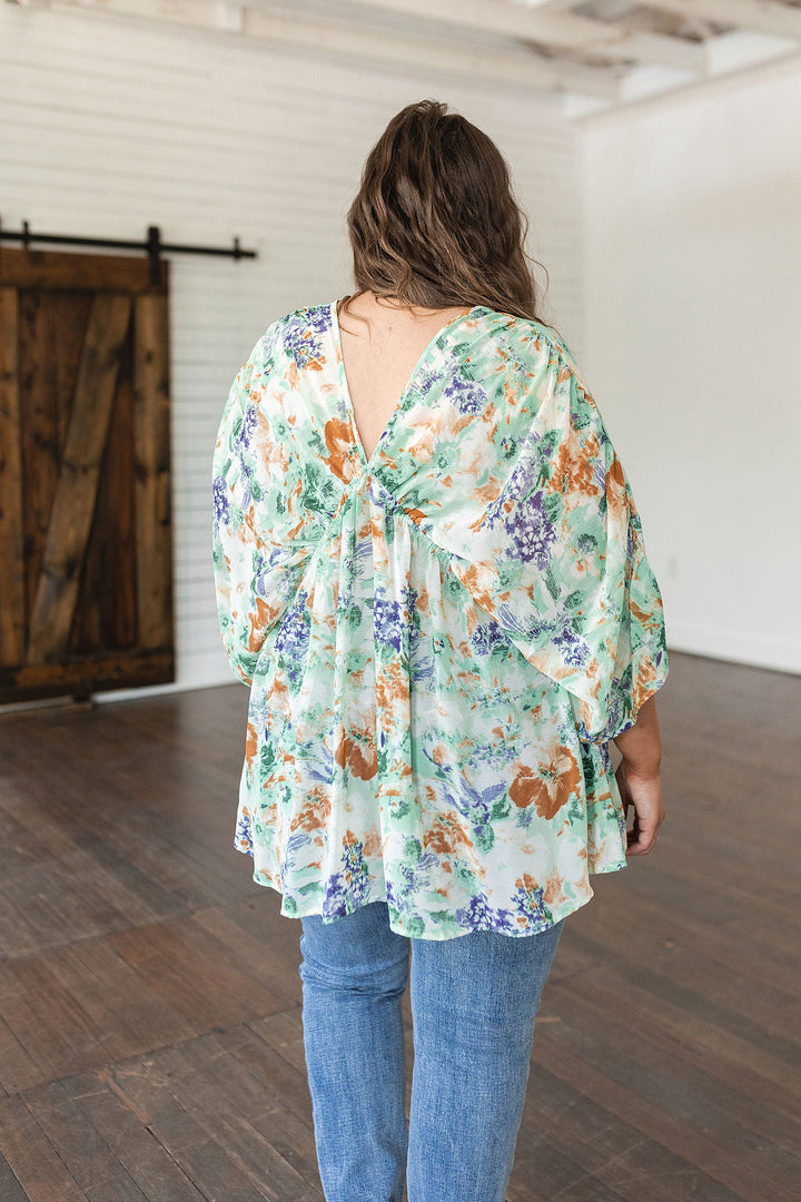 Fabled in Floral Draped Peplum Top in Ivory!