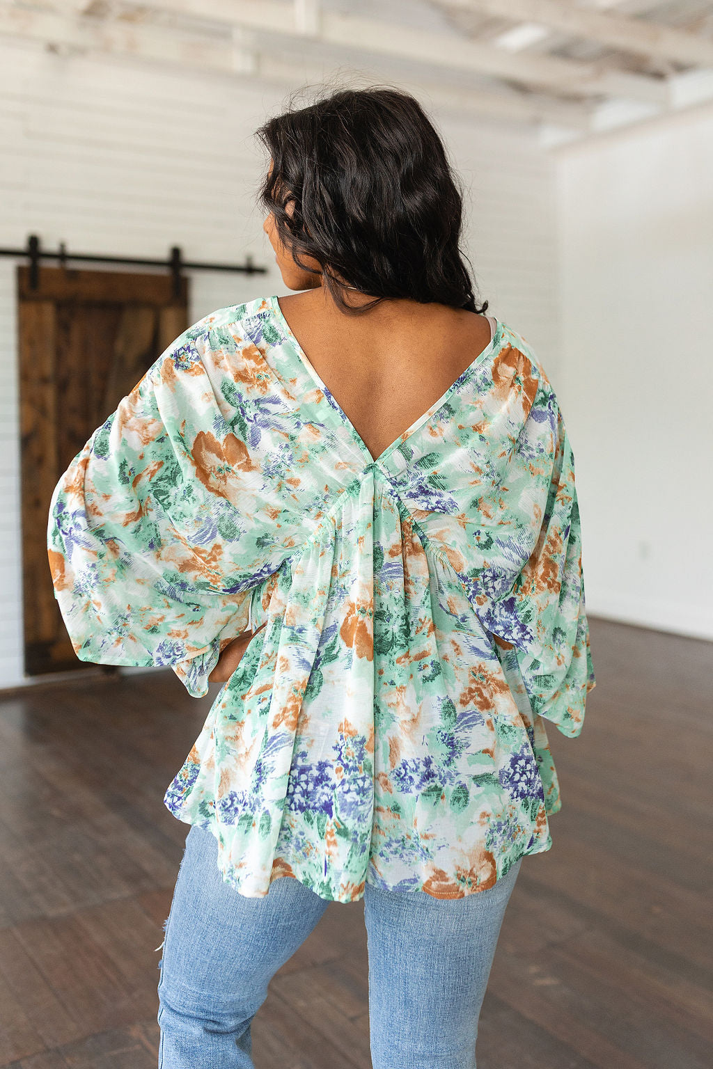 Fabled in Floral Draped Peplum Top in Ivory!