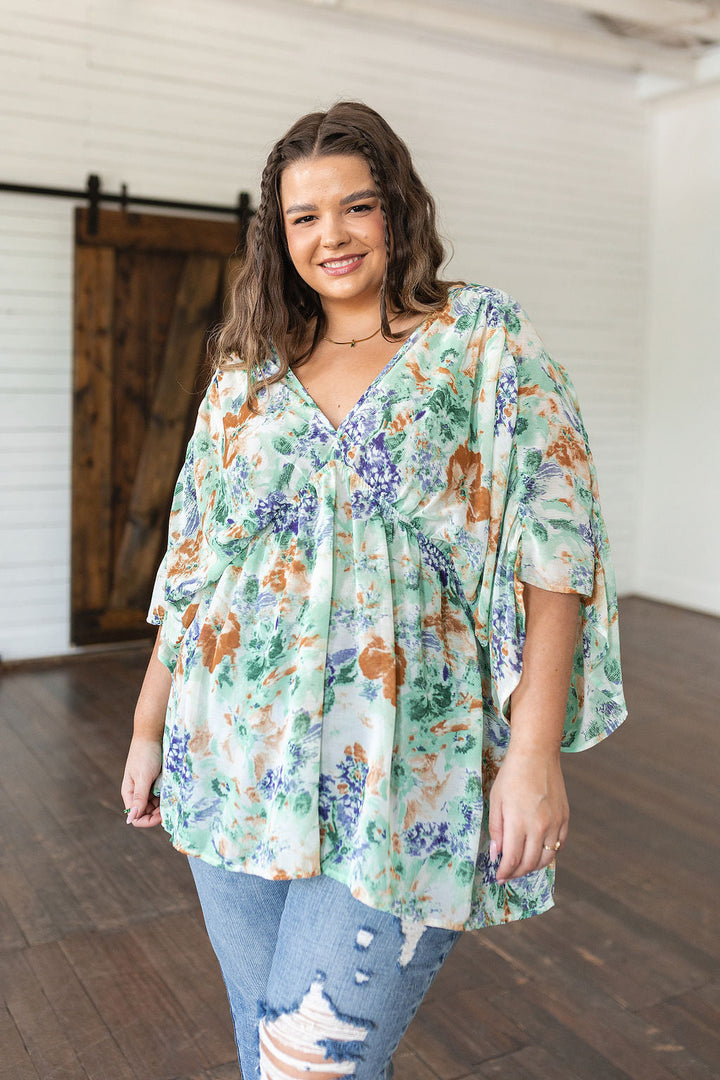 Fabled in Floral Draped Peplum Top in Ivory!