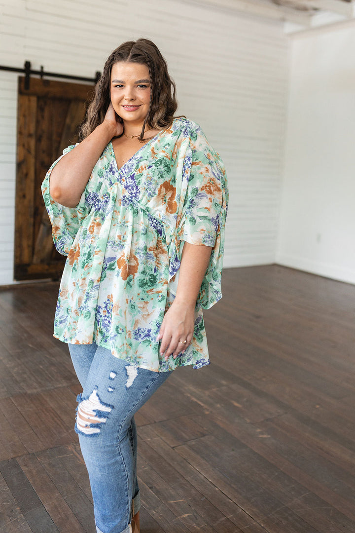 Fabled in Floral Draped Peplum Top in Ivory!