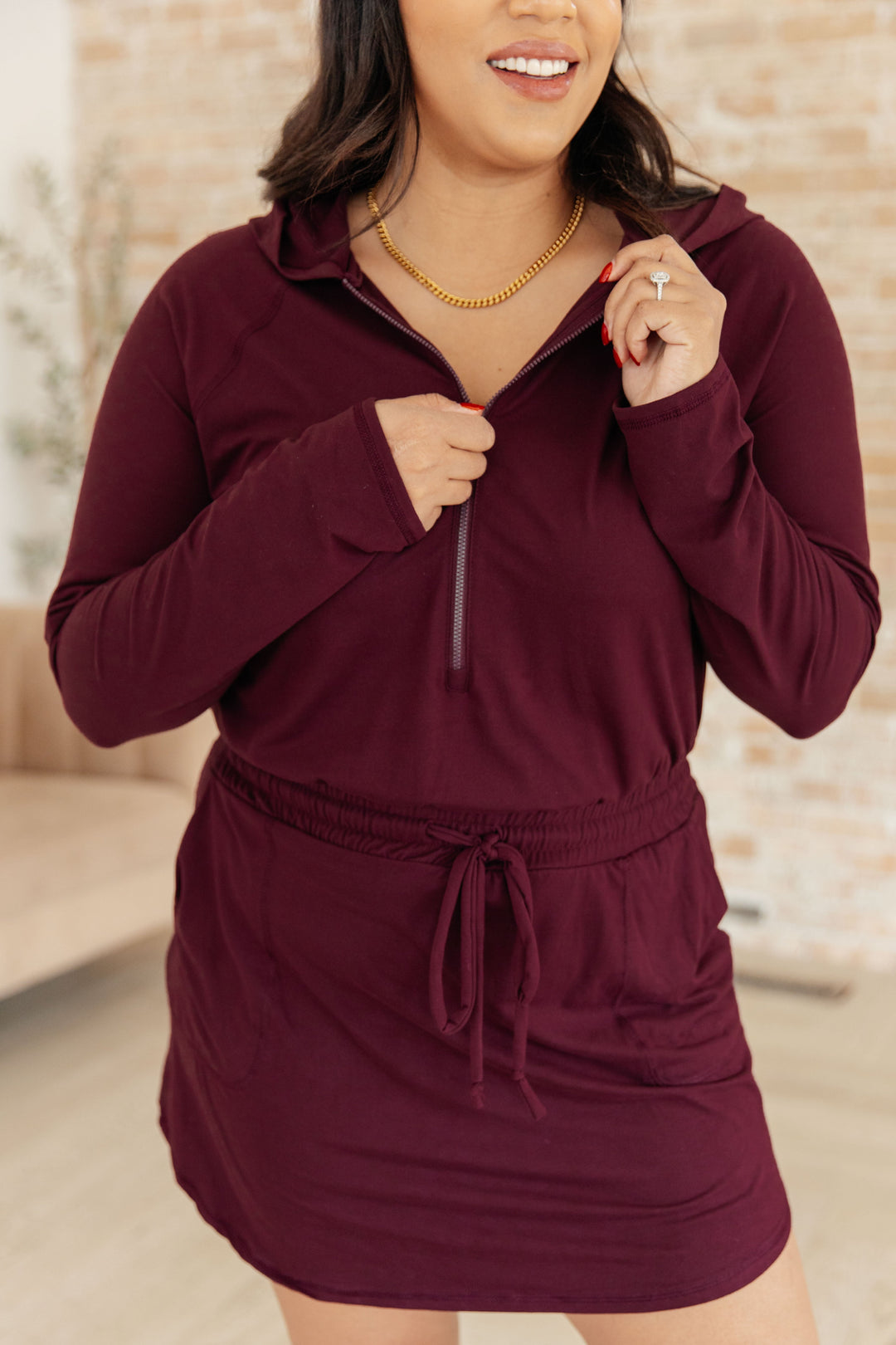 Getting Out Long Sleeve Hoodie Romper in Maroon!